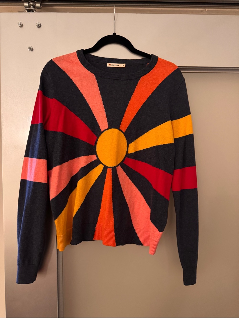 Marine Layer Blue Crewneck Sweater with Yellow, Red, Orange & Pink Sunburst